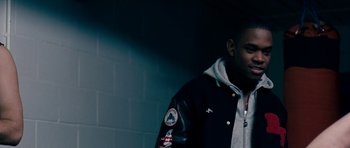 Movie still from “Kidulthood” (2006), directed by Menhaj Huda – A man wearing a black jacket standing in a dark room; Close Up shot, Low angle