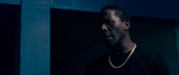 Movie still from “Kidulthood” (2006), directed by Menhaj Huda – A person wearing a black shirt; Close Up shot, Low angle