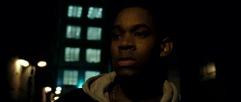 Movie still from “Kidulthood” (2006), directed by Menhaj Huda – A young man is crying in a dark room; Close Up shot, Low angle