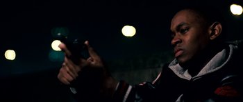 Movie still from “Kidulthood” (2006), directed by Menhaj Huda – A person taking a picture of the moon at night; Close Up shot, Over the shoulder angle