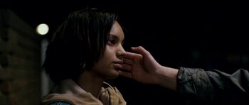 Movie still from “Kidulthood” (2006), directed by Menhaj Huda – A person touching the face of another person; Close Up shot, Over the shoulder angle