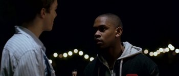 Movie still from “Kidulthood” (2006), directed by Menhaj Huda – A young man is talking to another young man; Close Up shot, Over the shoulder angle