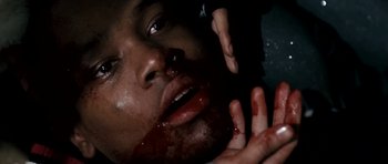 Movie still from “Kidulthood” (2006), directed by Menhaj Huda – A man with blood on his face and hands touching his head; Extreme Close Up shot, Overhead angle