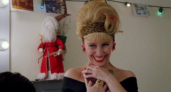 Movie still from “Kika” (1993), directed by Pedro Almodóvar – A woman in a black dress and a leopard print headband; Close Up shot, Low angle