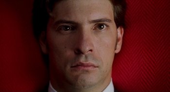 Movie still from “Kika” (1993), directed by Pedro Almodóvar – A man in a white shirt; Extreme Close Up shot, Overhead angle