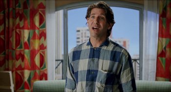 Movie still from “Kika” (1993), directed by Pedro Almodóvar – A man in a blue and white checkered shirt; Medium shot, Low angle