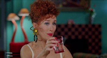 Movie still from “Kika” (1993), directed by Pedro Almodóvar – A person holding a glass of water; Close Up shot, Low angle