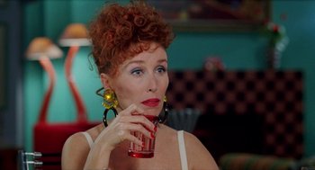 Movie still from “Kika” (1993), directed by Pedro Almodóvar – A person holding a glass of water; Close Up shot, Over the shoulder angle