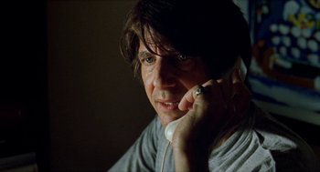 Movie still from “Kika” (1993), directed by Pedro Almodóvar – A person talking on a cell phone; Close Up shot, Low angle