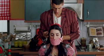 Movie still from “Kika” (1993), directed by Pedro Almodóvar – A man and a woman in the kitchen; Close Up shot, Over the shoulder angle