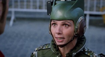 Movie still from “Kika” (1993), directed by Pedro Almodóvar – A woman wearing a green helmet and a green jacket; Close Up shot, High angle
