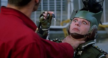 Movie still from “Kika” (1993), directed by Pedro Almodóvar – A man in a helmet is holding a screwdriver while another man holds a screwdriver; Close Up shot, Over the shoulder angle