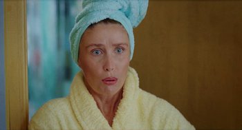 Movie still from “Kika” (1993), directed by Pedro Almodóvar – A person wearing a towel on their head; Close Up shot, High angle