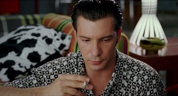 Movie still from “Kika” (1993), directed by Pedro Almodóvar – A person smoking a cigarette; Close Up shot, High angle