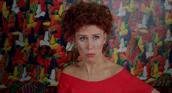 Movie still from “Kika” (1993), directed by Pedro Almodóvar – A person wearing a red dress; Close Up shot, Over the shoulder angle