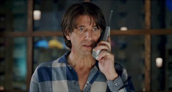 Movie still from “Kika” (1993), directed by Pedro Almodóvar – A person talking on a cell phone; Close Up shot, Low angle