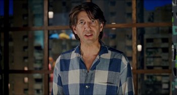 Movie still from “Kika” (1993), directed by Pedro Almodóvar – A person wearing a plaid shirt; Close Up shot, Over the shoulder angle