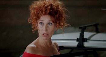 Movie still from “Kika” (1993), directed by Pedro Almodóvar – A person with curly red hair; Close Up shot, Over the shoulder angle