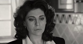 Movie still from “Kika” (1993), directed by Pedro Almodóvar – Black and white photograph of a woman looking at the camera; Close Up shot, Low angle