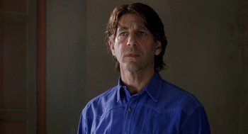 Movie still from “Kika” (1993), directed by Pedro Almodóvar – A person wearing a blue shirt; Close Up shot, Low angle