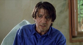 Movie still from “Kika” (1993), directed by Pedro Almodóvar – A person wearing a blue shirt; Close Up shot, Low angle