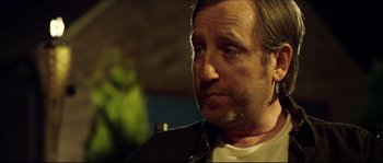 Movie still from “Kill List” (2011), directed by Ben Wheatley – A person wearing a leather jacket; Close Up shot, Over the shoulder angle