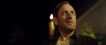 Movie still from “Kill List” (2011), directed by Ben Wheatley – A person looking up at the sky; Close Up shot, Low angle