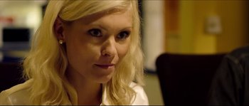 Movie still from “Kill List” (2011), directed by Ben Wheatley – A person with blonde hair; Close Up shot, Over the shoulder angle