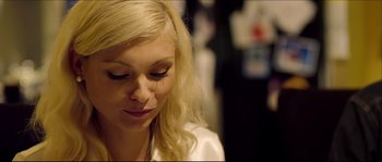 Movie still from “Kill List” (2011), directed by Ben Wheatley – A woman with blonde long hair and a white shirt; Close Up shot, Over the shoulder angle