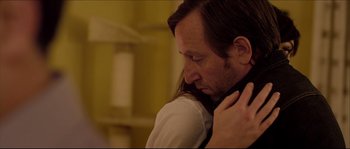 Movie still from “Kill List” (2011), directed by Ben Wheatley – A man and a woman embracing each other; Close Up shot, Over the shoulder angle