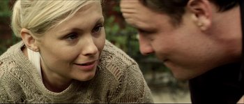 Movie still from “Kill List” (2011), directed by Ben Wheatley – A man and a woman sitting next to each other; Close Up shot, Over the shoulder angle