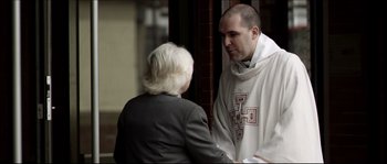 Movie still from “Kill List” (2011), directed by Ben Wheatley – A man and a woman are talking outside; Medium shot, Over the shoulder angle