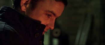 Movie still from “Kill List” (2011), directed by Ben Wheatley – A man's face in the dark; Close Up shot, Low angle