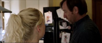 Movie still from “Kill List” (2011), directed by Ben Wheatley – A man and a woman talking in front of a refrigerator; Close Up shot, Over the shoulder angle