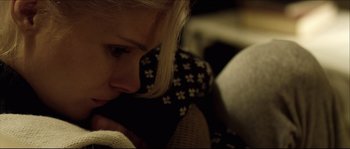 Movie still from “Kill List” (2011), directed by Ben Wheatley – A woman's face as she leans on a pillow; Close Up shot, High angle