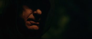 Movie still from “Kill List” (2011), directed by Ben Wheatley – A person's face in the dark; Extreme Close Up shot, Low angle