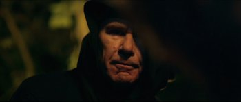 Movie still from “Kill List” (2011), directed by Ben Wheatley – A person wearing a hat; Close Up shot, Low angle