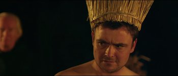 Movie still from “Kill List” (2011), directed by Ben Wheatley – A person wearing a hat; Close Up shot, Over the shoulder angle