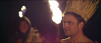 Movie still from “Kill List” (2011), directed by Ben Wheatley – A person wearing a headdress; Close Up shot, Low angle