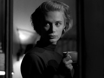Movie still from “Killer's Kiss” (1955), directed by Stanley Kubrick – A black and white photo of a woman holding a coffee cup; Close Up shot, Over the shoulder angle