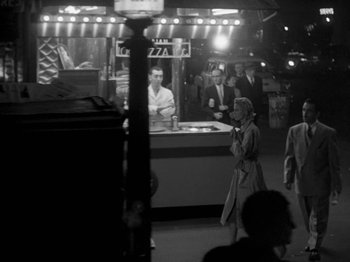 Movie still from “Killer's Kiss” (1955), directed by Stanley Kubrick – A black and white photo of people in a market; Wide shot, High angle