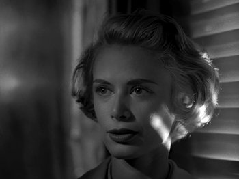 Movie still from “Killer's Kiss” (1955), directed by Stanley Kubrick – A black - and - white photo of a woman's face; Close Up shot, Low angle