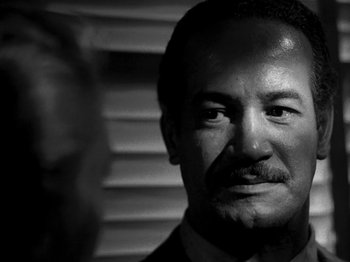 Movie still from “Killer's Kiss” (1955), directed by Stanley Kubrick – Black and white photograph of a man with a mustache; Close Up shot, Low angle