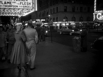 Movie still from “Killer's Kiss” (1955), directed by Stanley Kubrick – An old photo of people walking down the street at night; Wide shot, Low angle