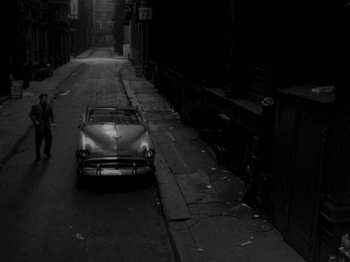 Movie still from “Killer's Kiss” (1955), directed by Stanley Kubrick – A car parked on the side of the street; Extreme Wide shot, High angle