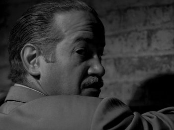Movie still from “Killer's Kiss” (1955), directed by Stanley Kubrick – An older man with a mustache is looking at something; Close Up shot, Low angle