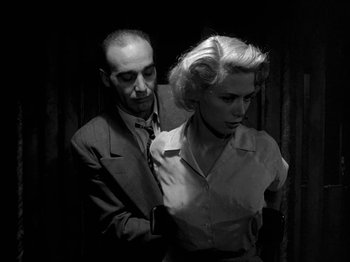 Movie still from “Killer's Kiss” (1955), directed by Stanley Kubrick – A black and white photo of a man and a woman; Medium shot, Low angle