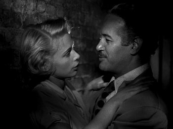 Movie still from “Killer's Kiss” (1955), directed by Stanley Kubrick – A man and a woman are looking at each other; Close Up shot, Low angle