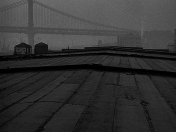 Movie still from “Killer's Kiss” (1955), directed by Stanley Kubrick – A black and white photo of a bridge in the fog; Extreme Wide shot, Low angle