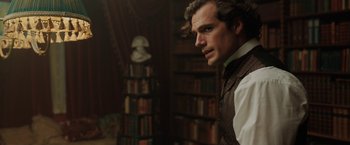 Movie still from “Enola Holmes” (2020), directed by Harry Bradbeer – A person wearing a suit and tie; Close Up shot, Over the shoulder angle